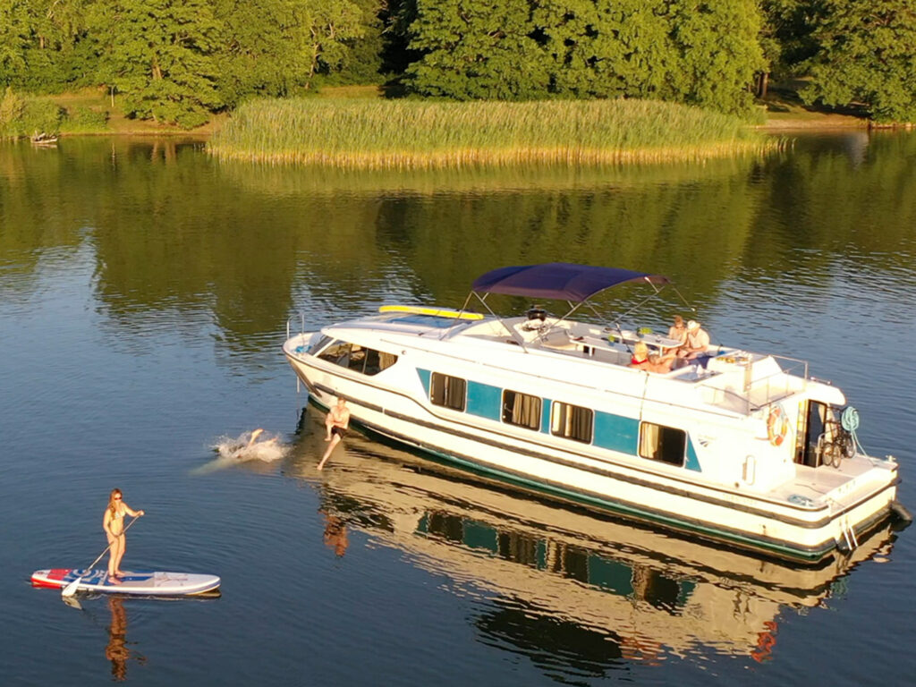 Paddleboarder next to Le Boat charter