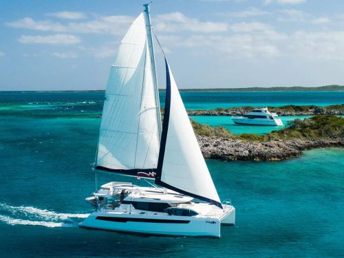 The Moorings sailboat on the water near a reef.