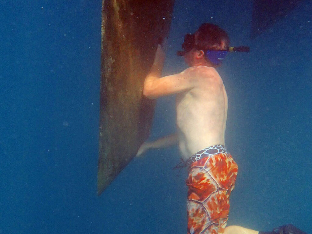 Jamie underwater, grabbing the rudder